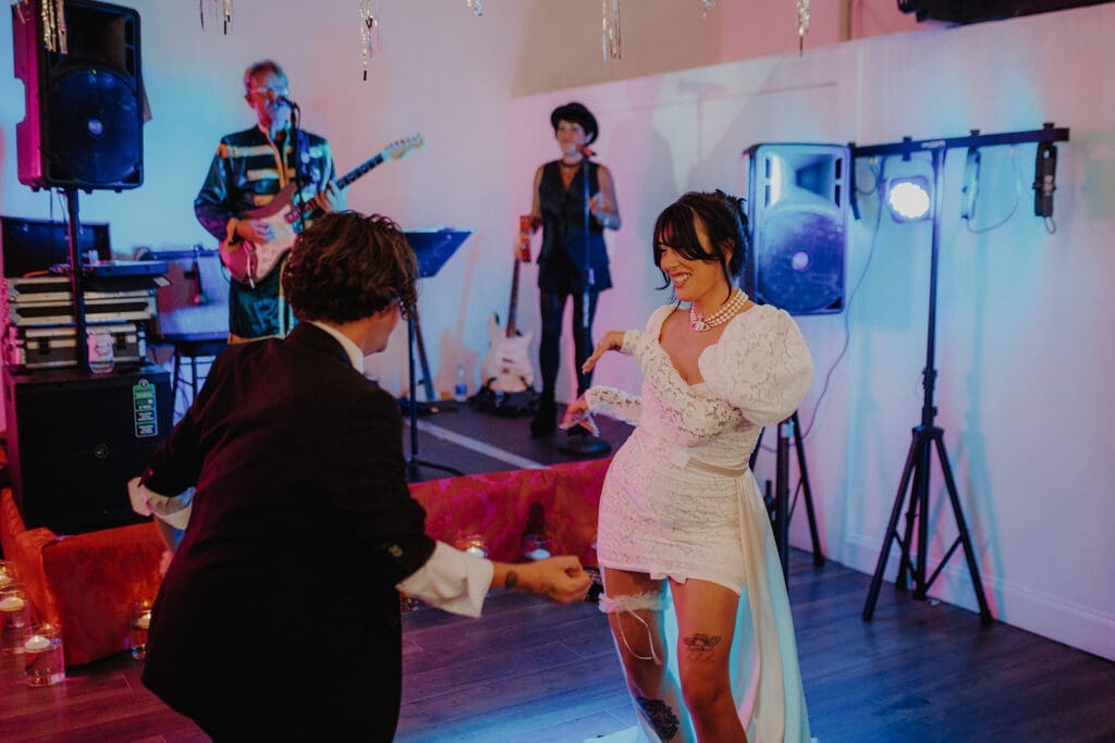 Newlyweds boogie down for their first dance with a band in the background