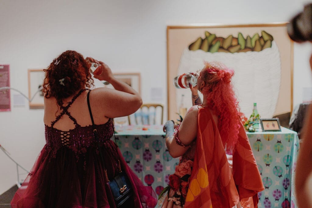 A newlywed and their bestie take shots from spirit bottles together!